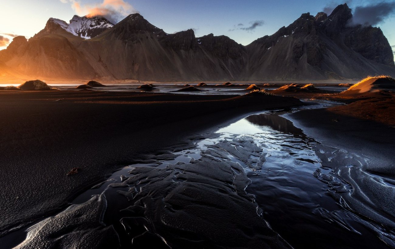 Montagnes sombres et plage de sable noir au soleil couchant, film de Studio 47